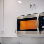 Moderná mikrovlnná rúra v kuchyni s digitálnym ovládaním.